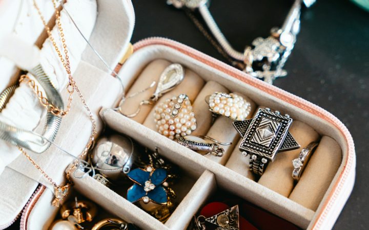 Open divided jewelry box with rings and accessories