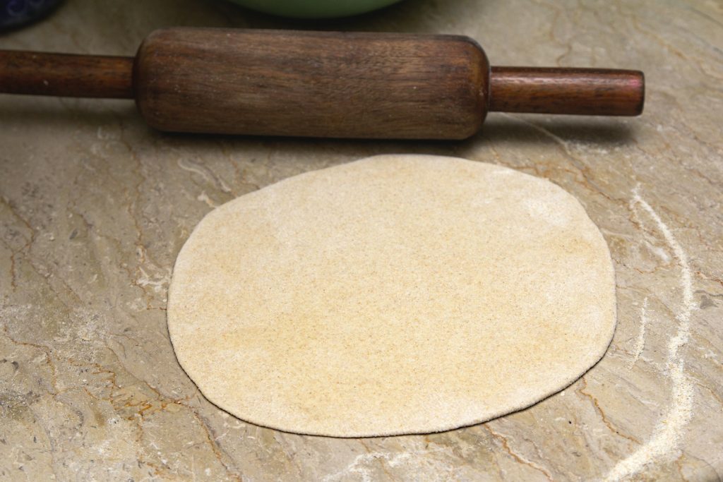 Rolling pin and rolled dough on a work surface