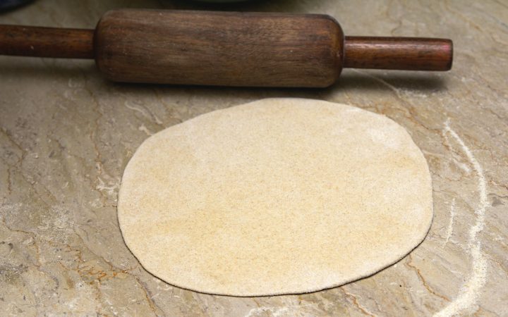 Rolling pin and rolled dough on a work surface