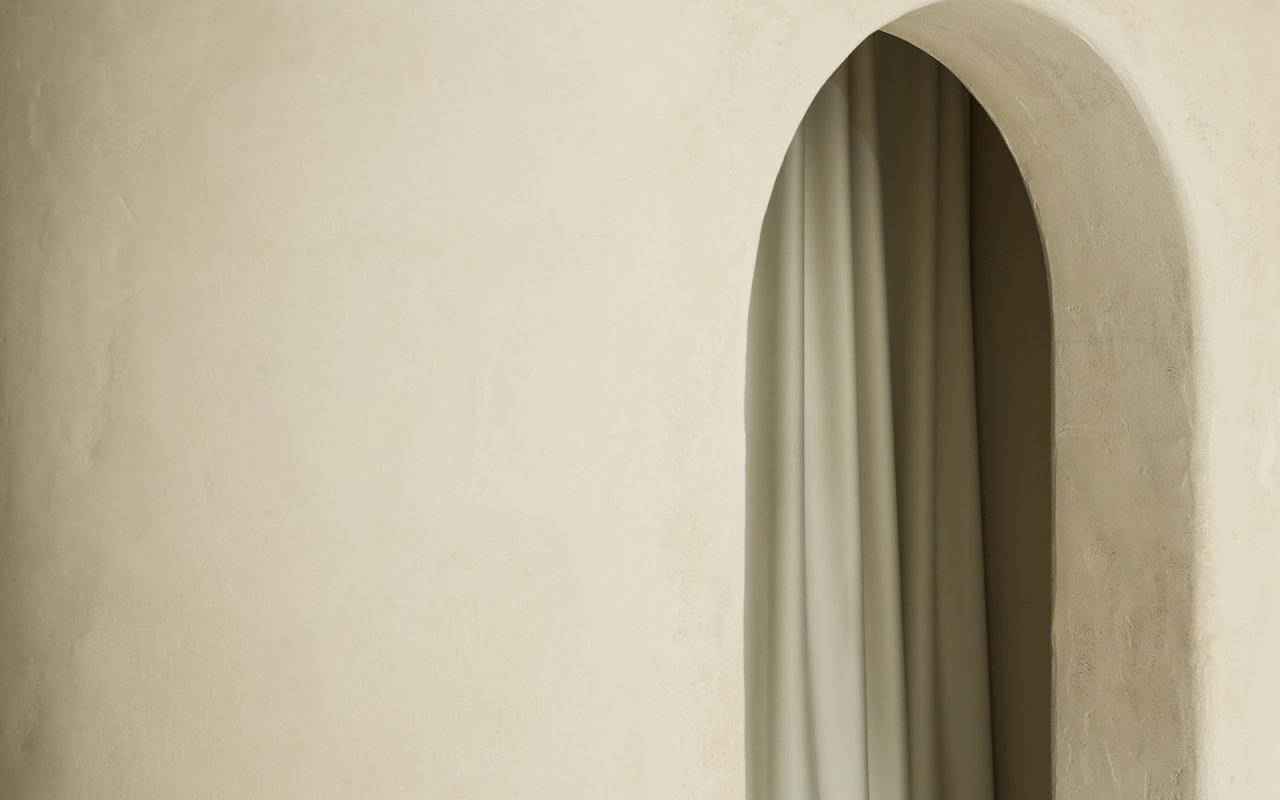 Curtain hanging inside an arched opening