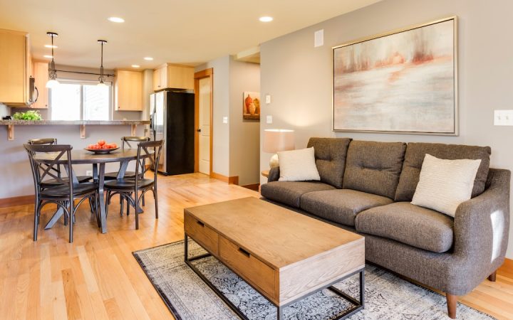 Living room with sofa and open floor area ready for a focused seasonal cleaning session
