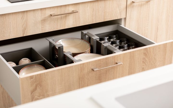 Kitchen drawer with organized dishes and divided storage sections