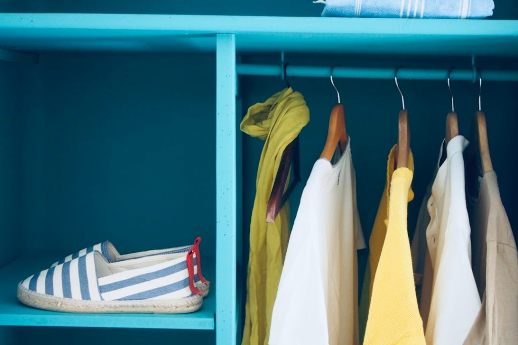 Closet with hanging clothing and contained storage zones