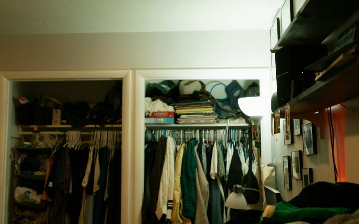 Crowded closet filled with clothes, books, and household items, illustrating a small home that feels too full