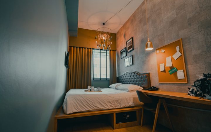 Tidy small bedroom with white bedding and limited visible clutter