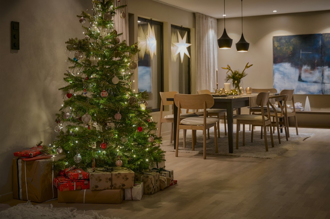 Wrapped gifts arranged around a seasonal focal point in a compact living room