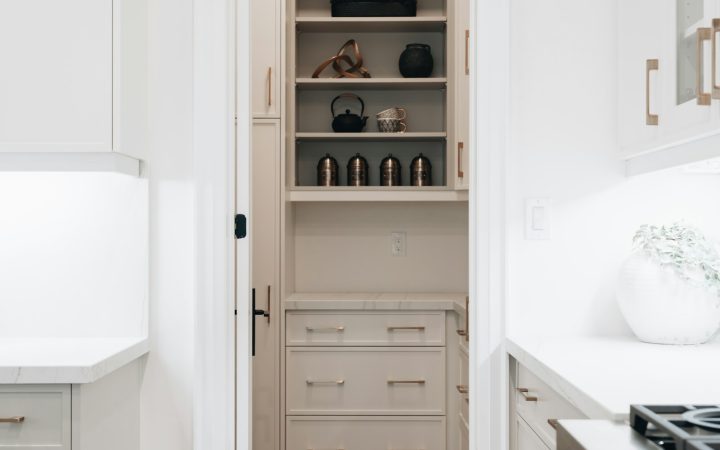 Modern pantry with a mix of open shelving and closed kitchen storage