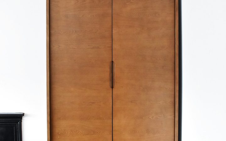 Small apartment entryway with a narrow bench and wall storage