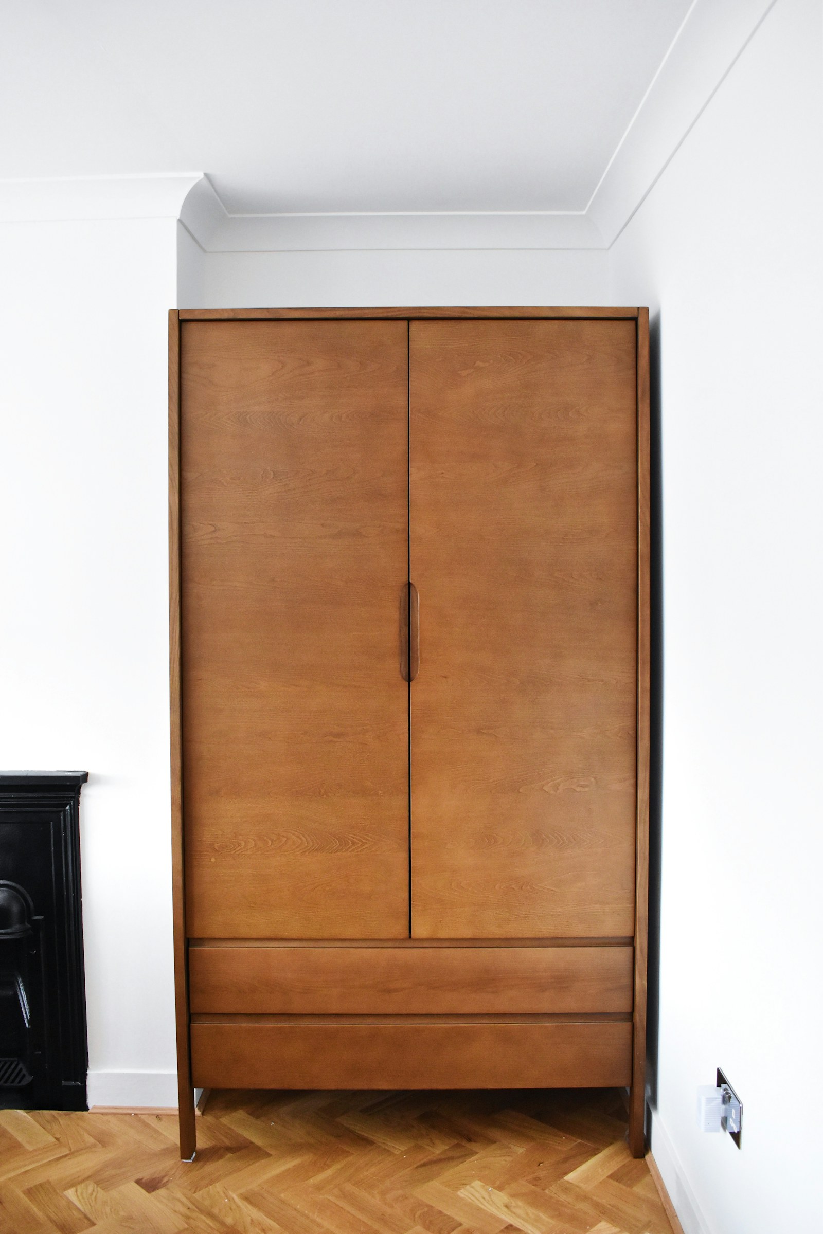 Small apartment entryway with a narrow bench and wall storage