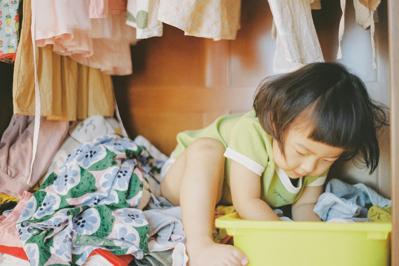 Child beside low household storage illustrating reachable family zones