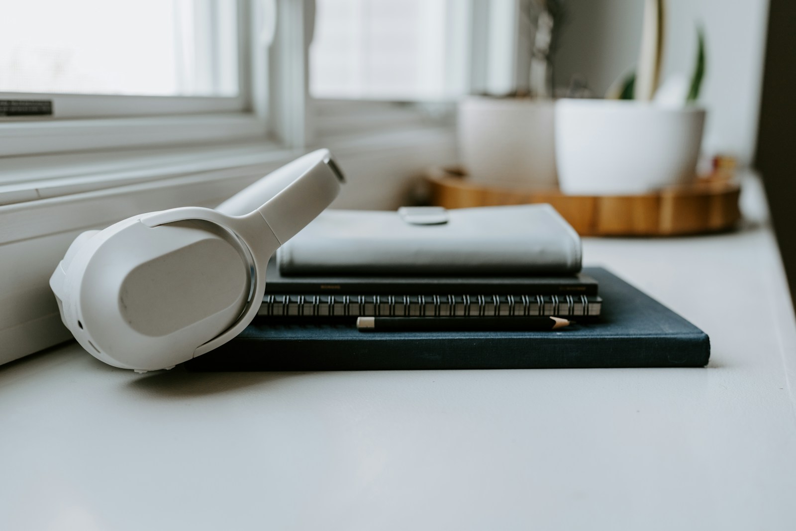 Headphones and notebooks on a desk