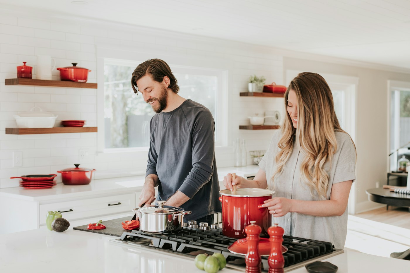 Two adults working together in a kitchen during a household routine