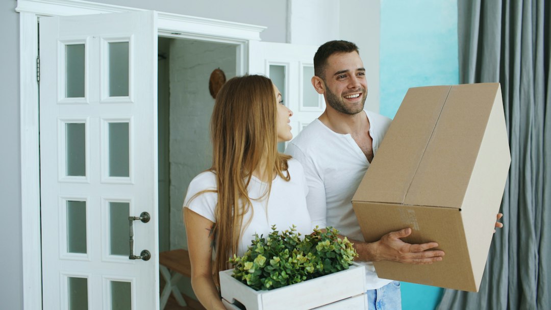 Couple standing among moving boxes during the first days after relocation