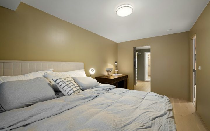 Bedside table with restrained items next to a bed