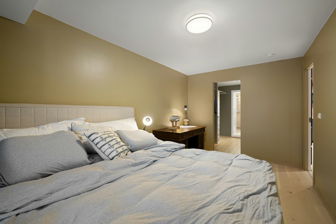 Bedside table with restrained items next to a bed