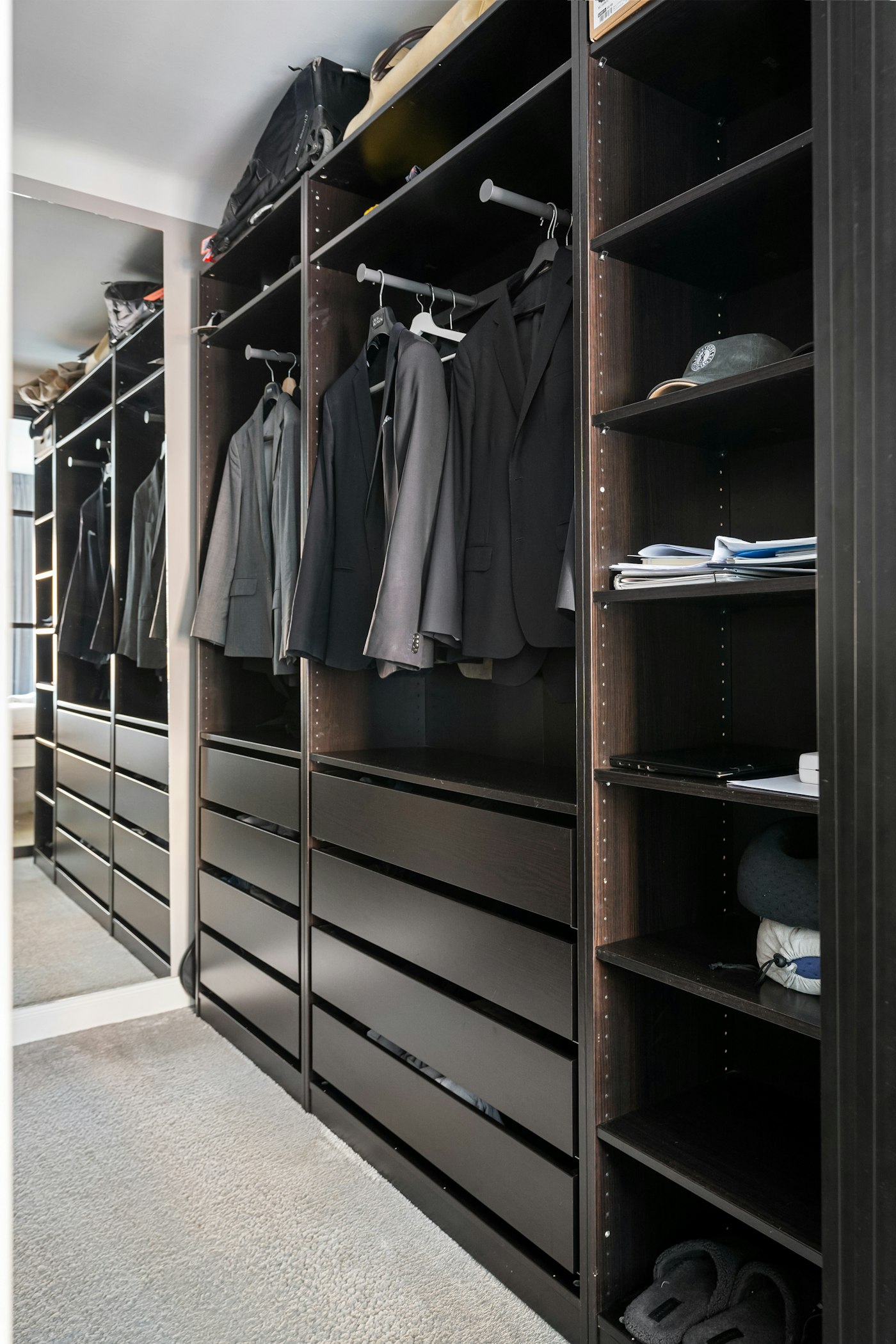 Walk-in closet filled with clothes, showing how a defined storage boundary can guide what stays