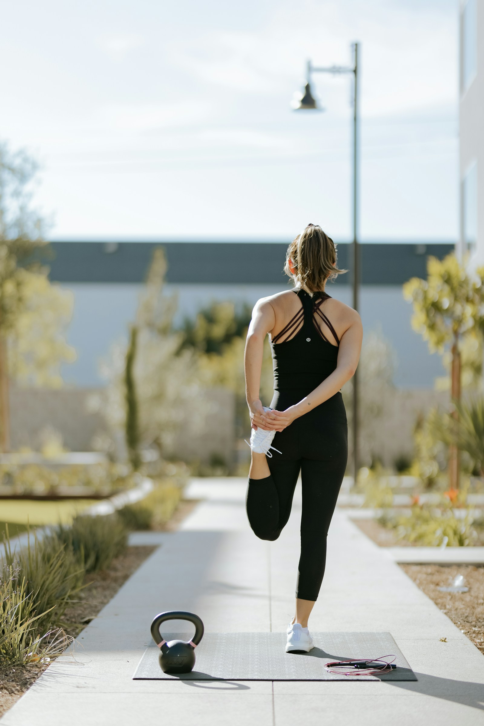 Person exercising with a mat and kettlebell