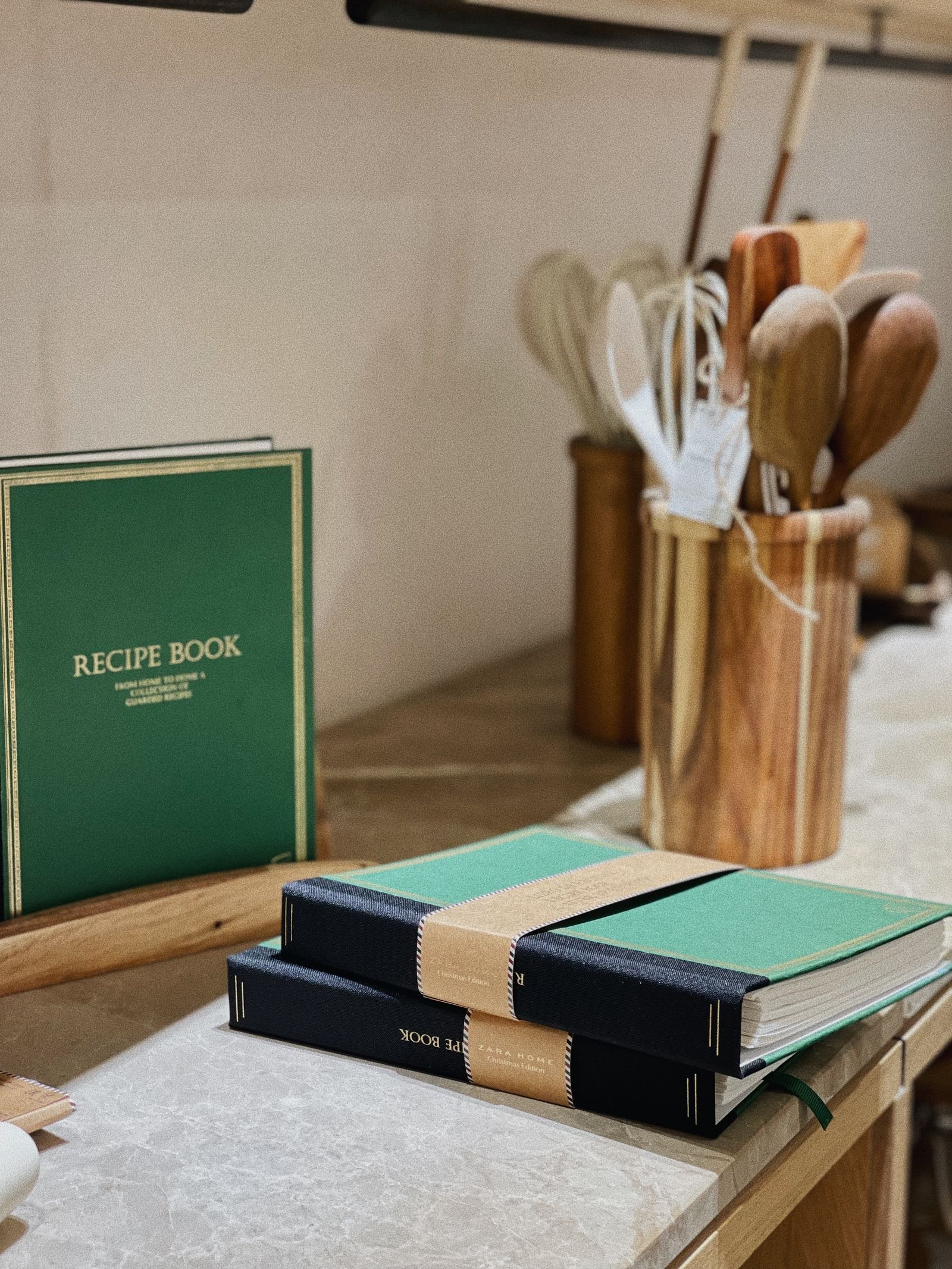 Recipe books beside kitchen utensils