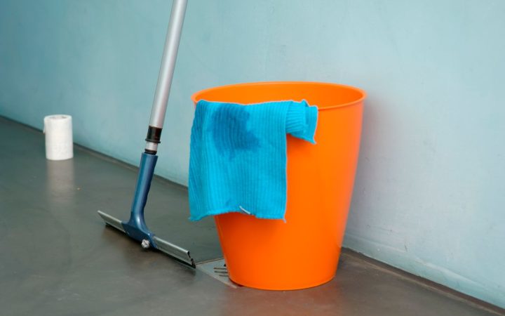 Cleaning bucket, mop, and cloth arranged for a simple floor-cleaning routine