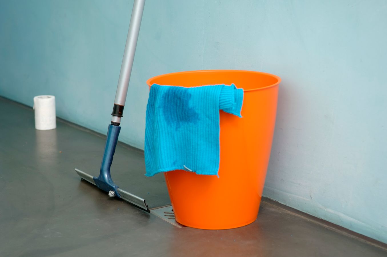 Cleaning bucket, mop, and cloth arranged for a simple floor-cleaning routine