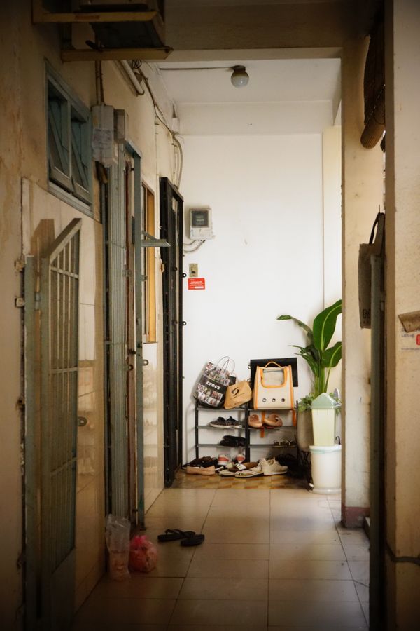 Compact apartment hallway with a shoe rack and clear floor space, illustrating no-drill entryway storage