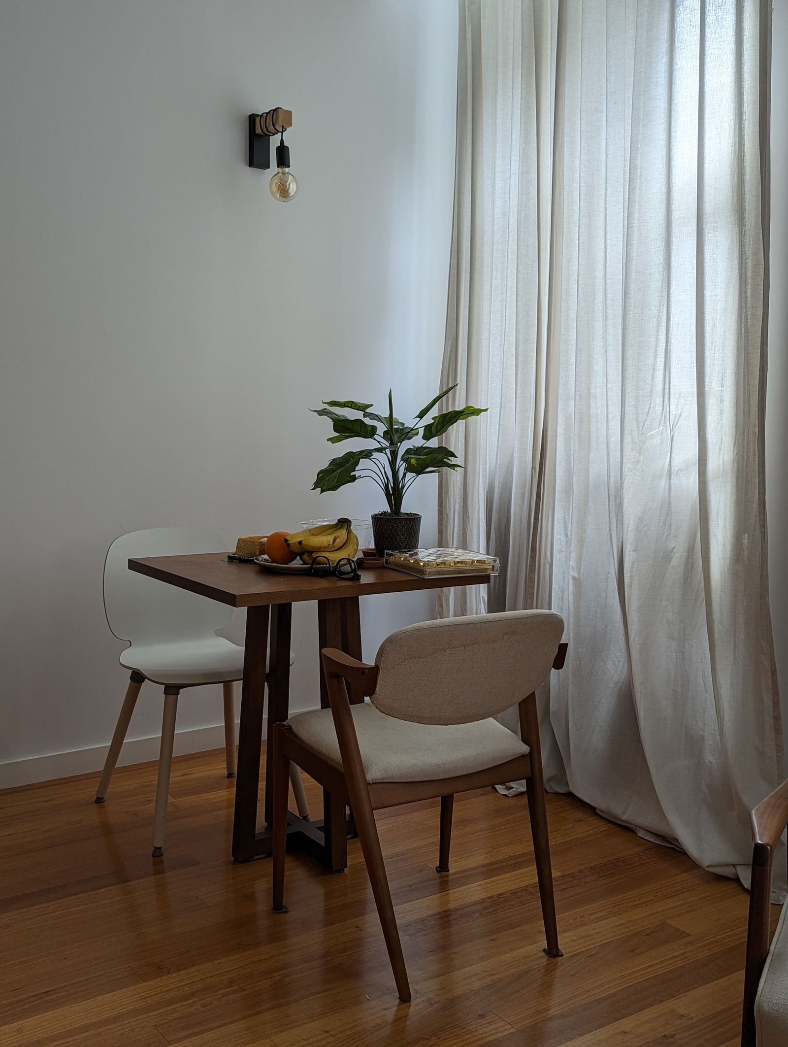 Compact dining nook with table chairs and natural light
