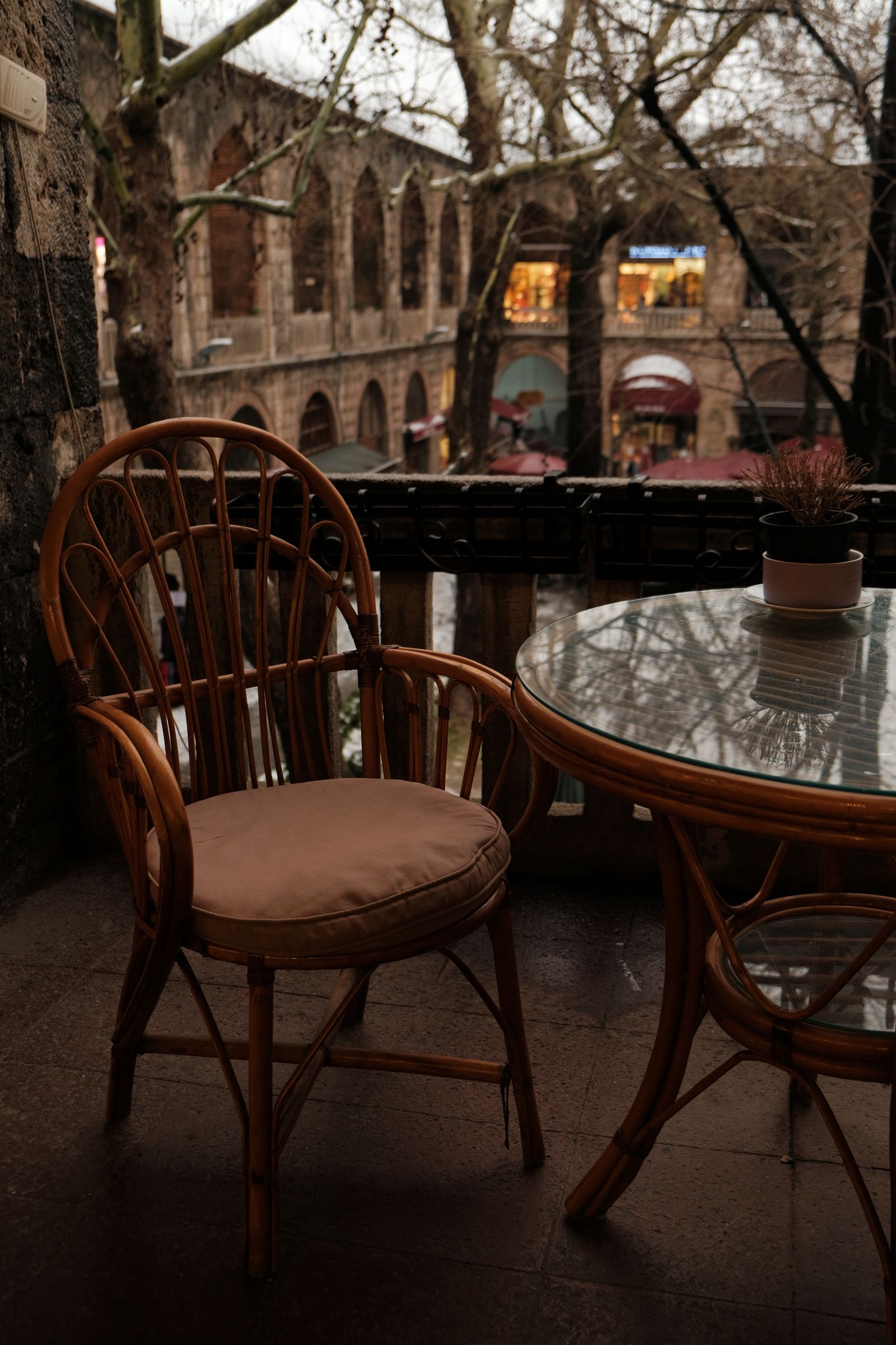A wooden chair and small table on a balcony