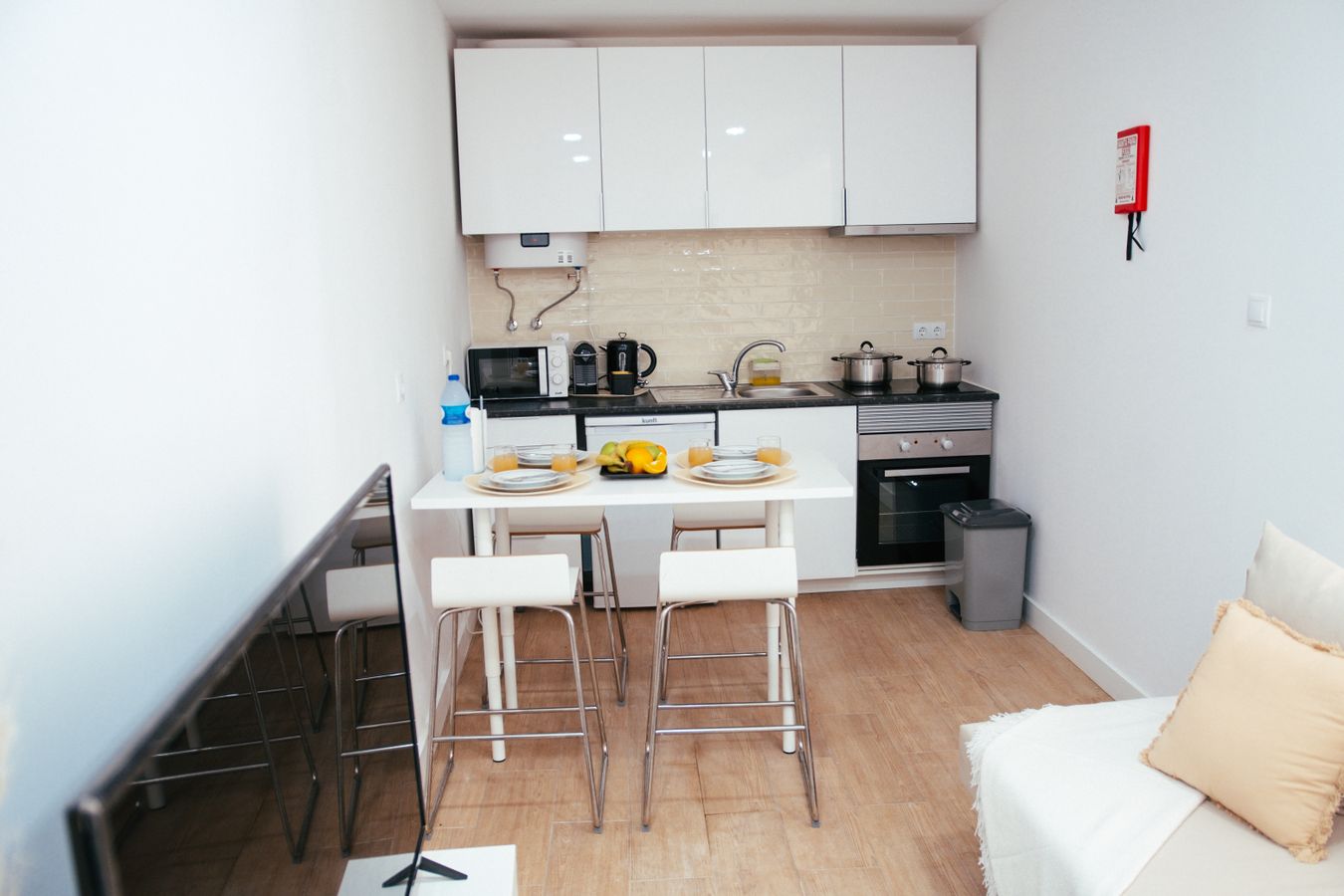 Small apartment interior showing practical furniture placement and organized storage