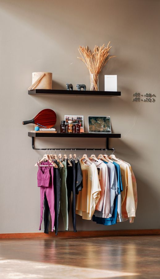 Freestanding clothing rack and shelves in a small apartment, illustrating renter-friendly storage