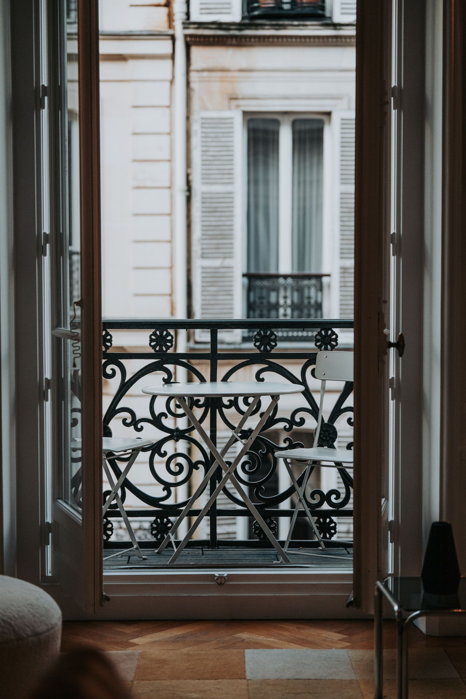 Open doors leading onto a narrow wrought-iron balcony