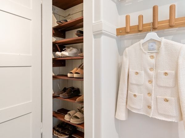 Compact apartment closet with organized shoe shelves and no permanent wall installation