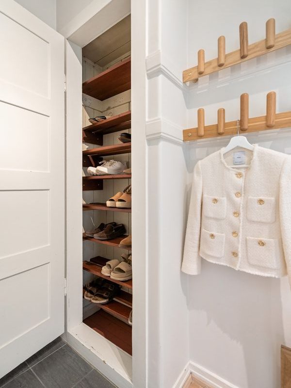 Compact apartment closet with organized shoe shelves and no permanent wall installation