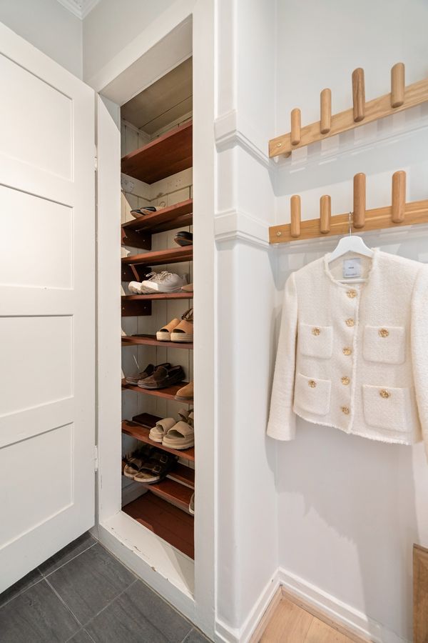 Compact apartment closet with organized shoe shelves and no permanent wall installation