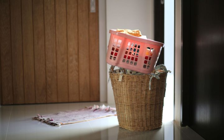 Two laundry baskets filled with clothing near a doorway, illustrating capacity and floor footprint