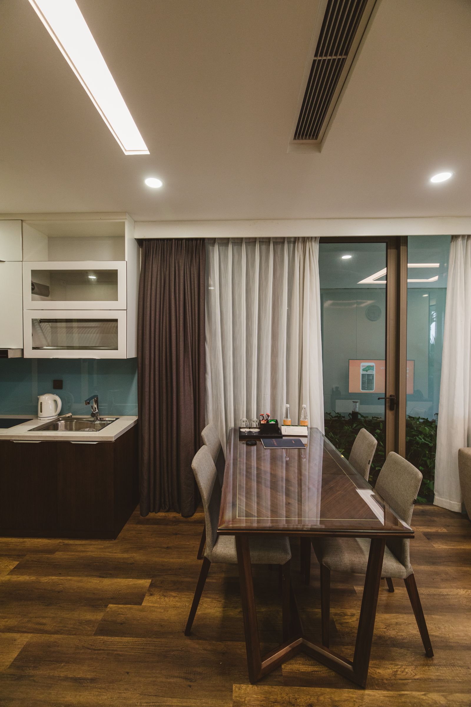 Small dining area with furniture and nearby kitchen storage