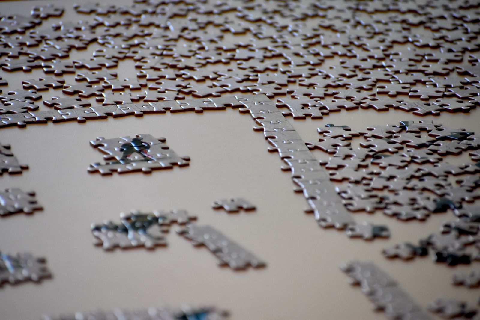 Loose jigsaw pieces arranged around small connected sections