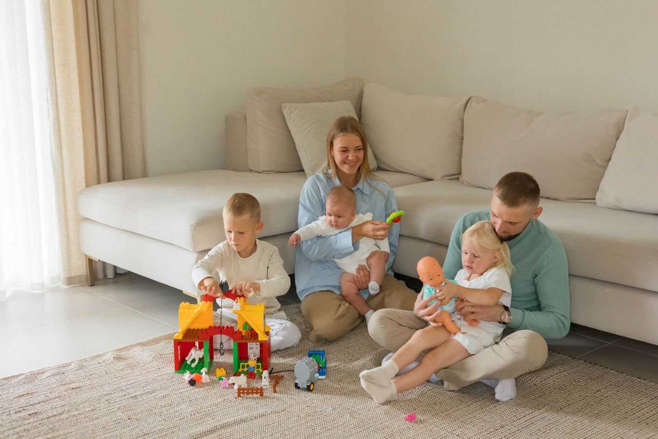 Family playing with toys in a modern living room, showing how play can share space with everyday living