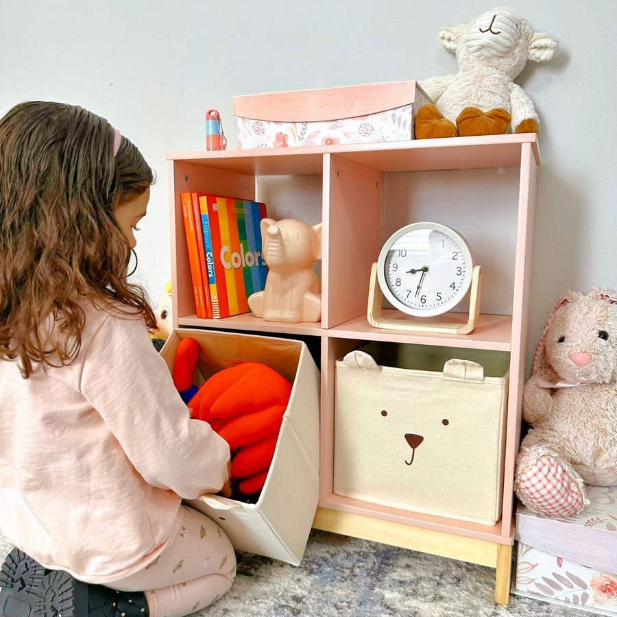 Child organizing toys on a low shelf, illustrating an active set children can help reset