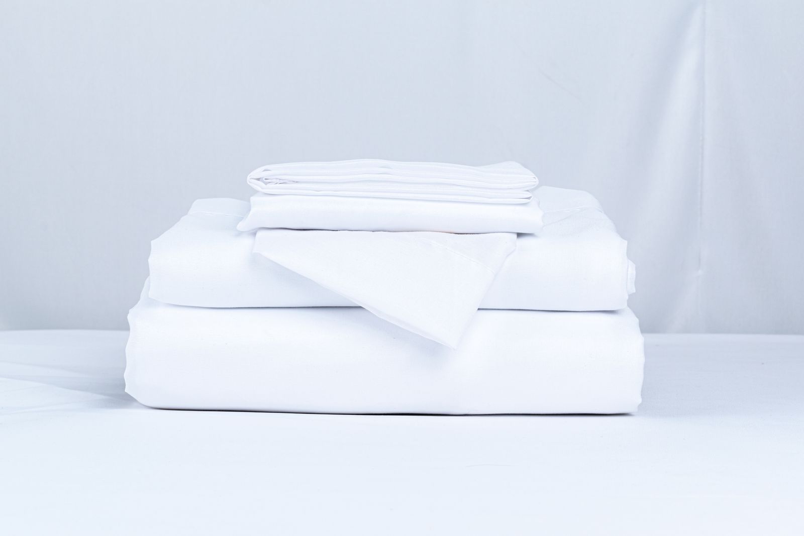A stack of clean folded bed linens