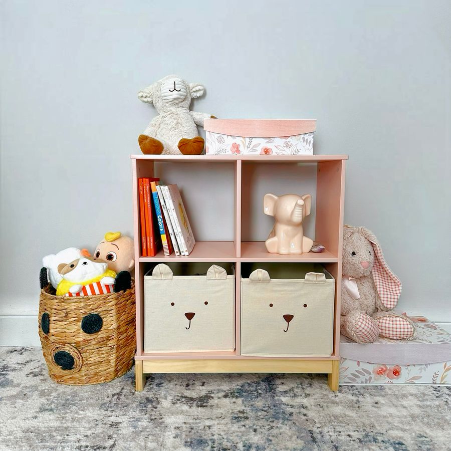 Organized children's shelf with books, toys, and baskets illustrating contained toy storage