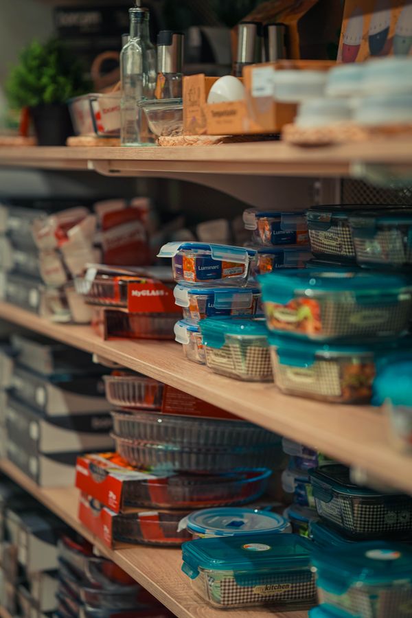 Organized kitchen pantry shelves with storage containers and clearly visible categories