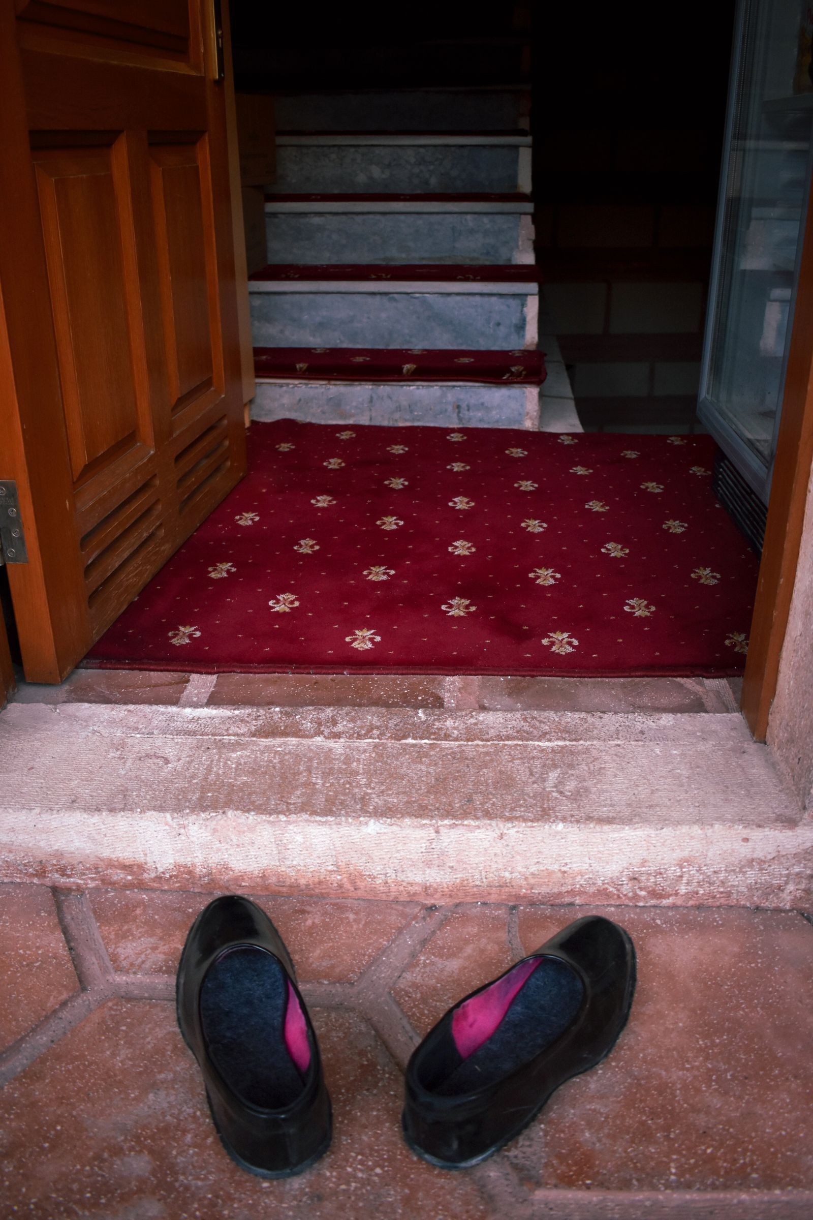 Warm home entrance with shoes arranged by the door