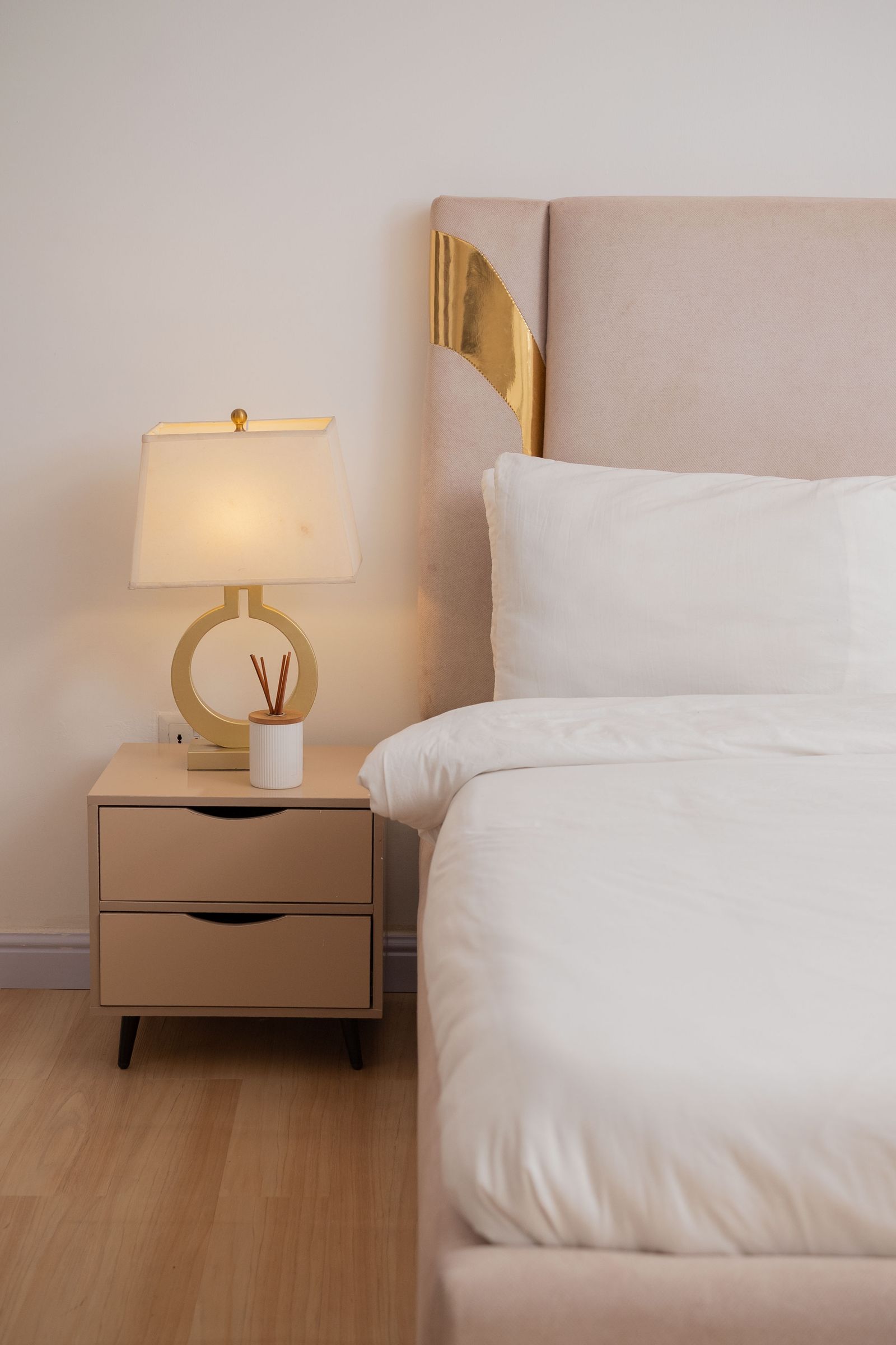 A bedside table lamp beside a bed