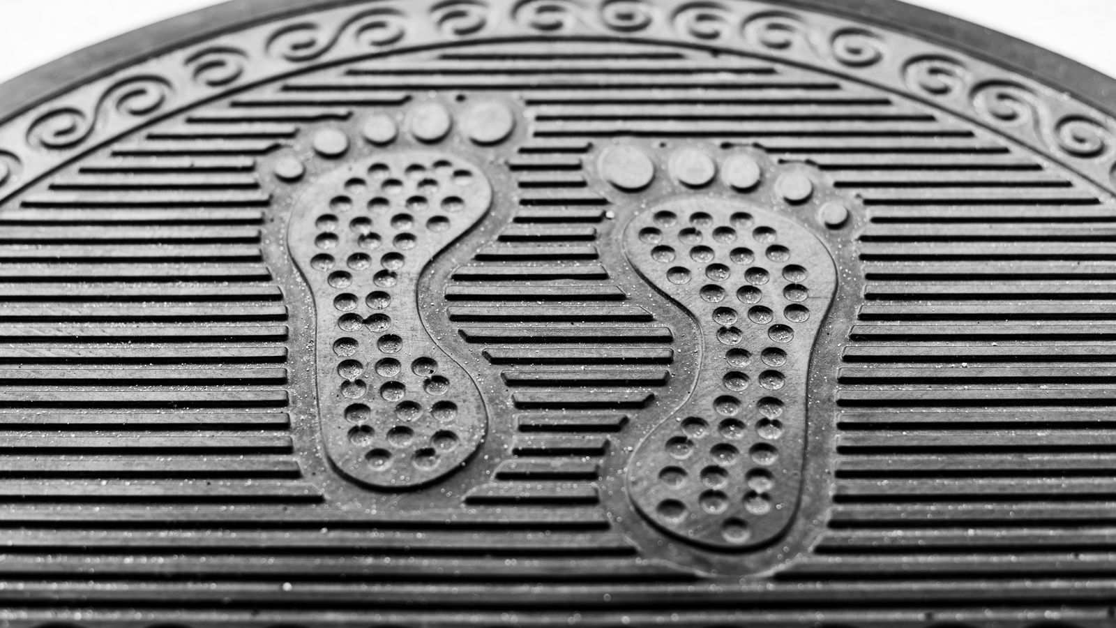 Textured rubber doormat designed to trap dirt