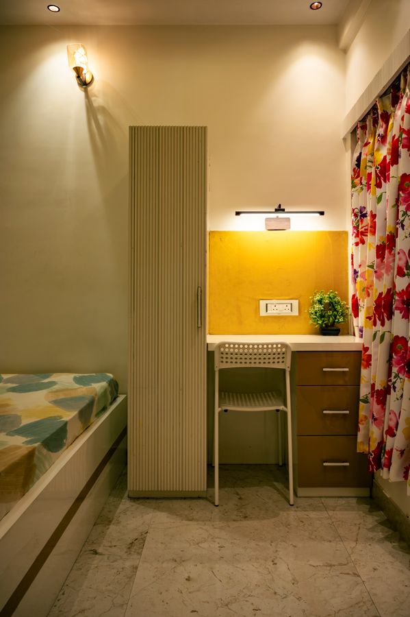 Small bedroom with a desk and bed sharing one room without blocking circulation