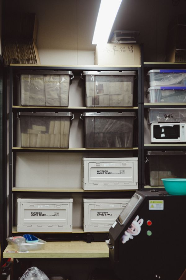 Storage shelving filled with clearly grouped containers and boxes