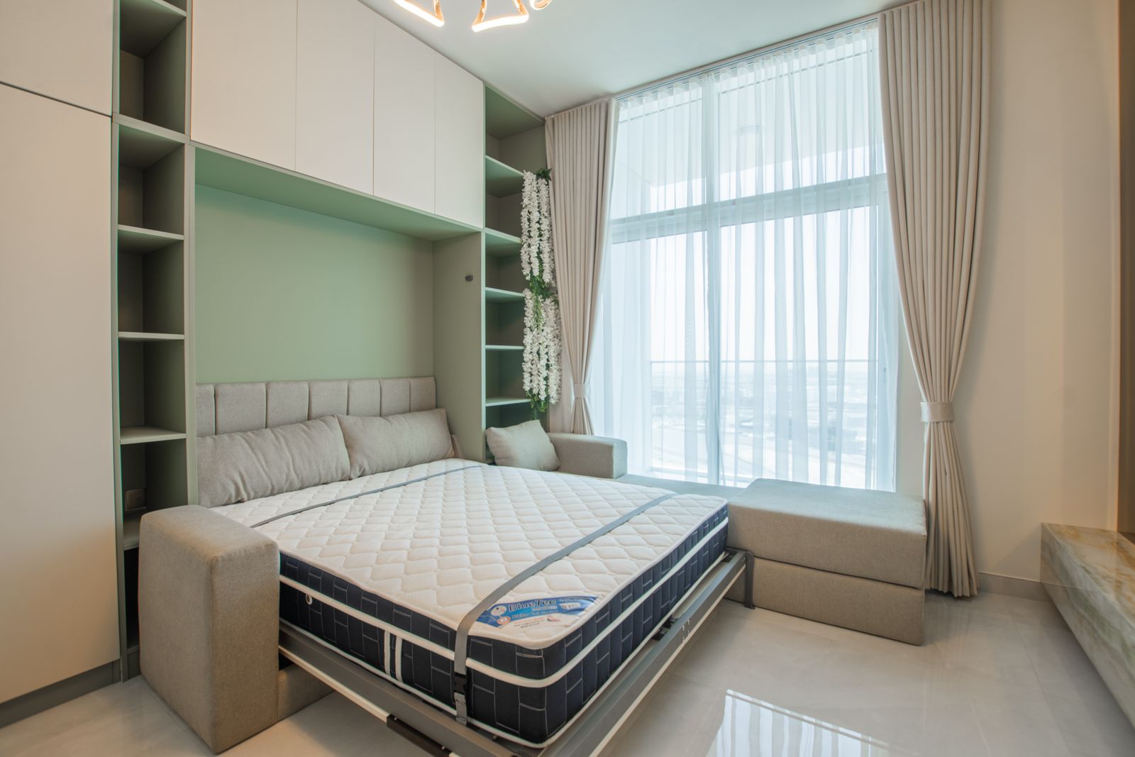 Modern folding bed arranged in a compact room