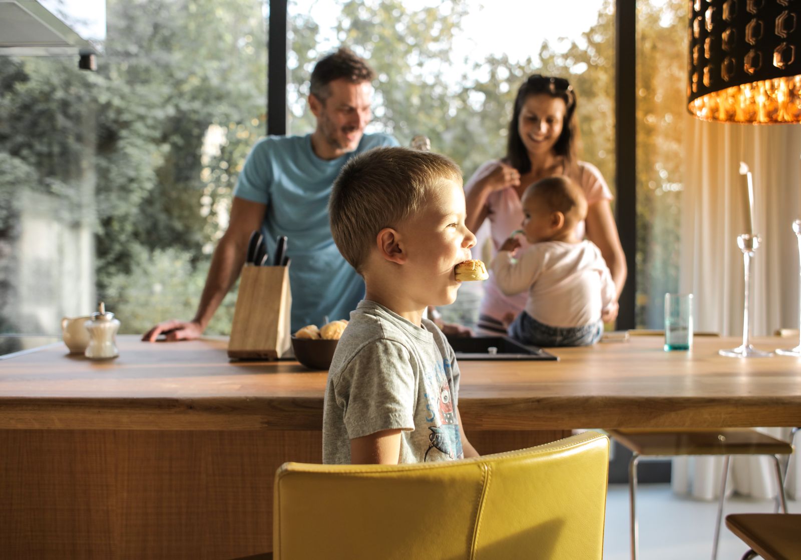 Child eating at the table with family
