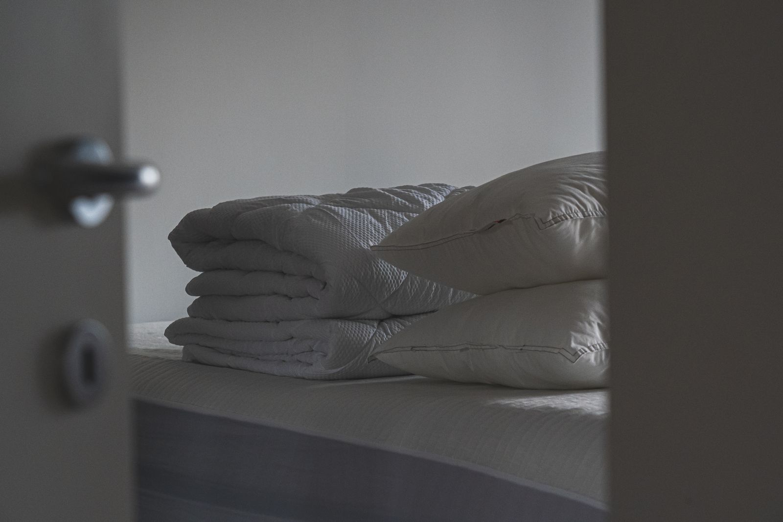 Stacked pillows and folded blankets prepared for guests