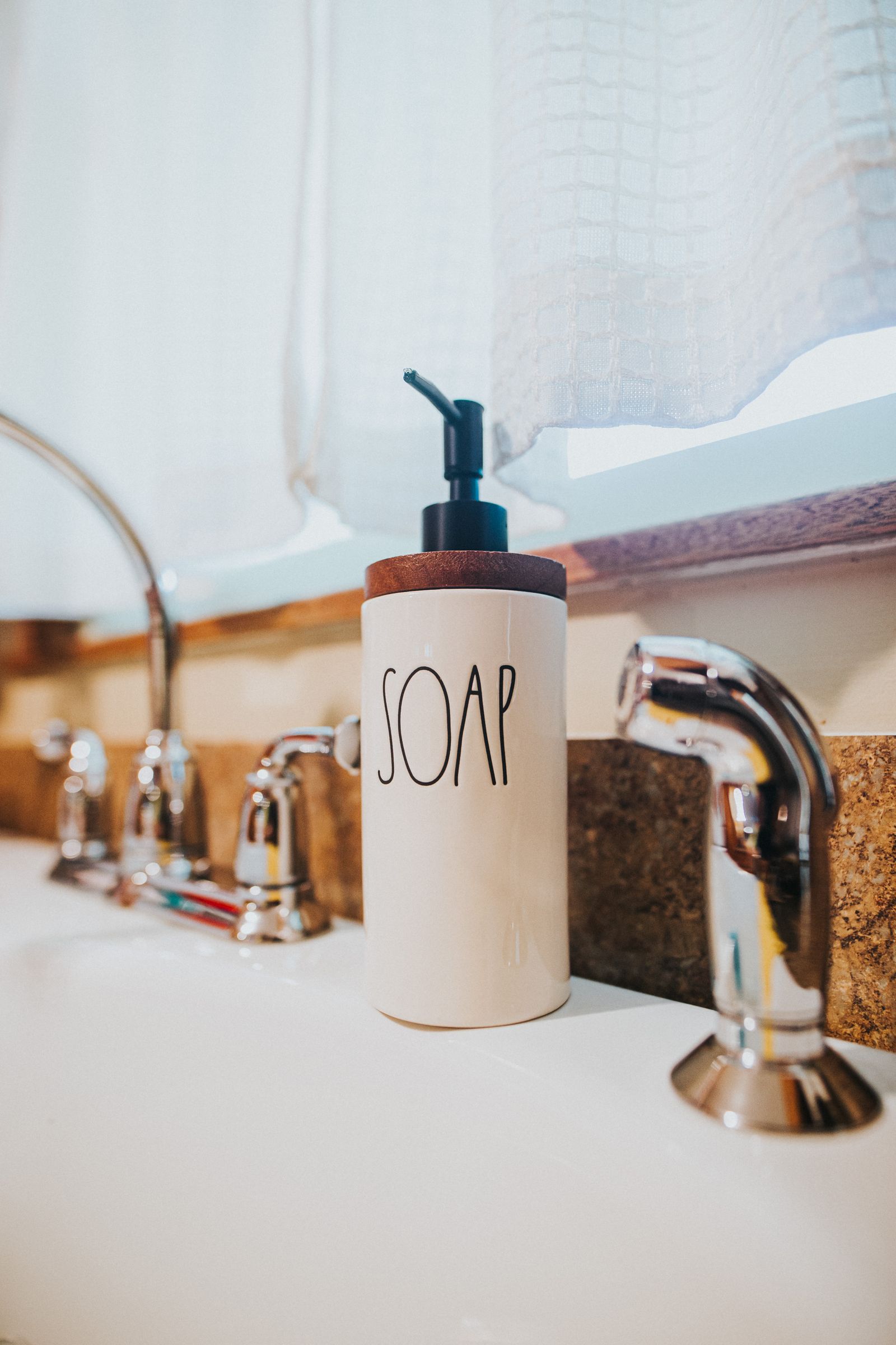Ceramic soap dispenser on a wash basin